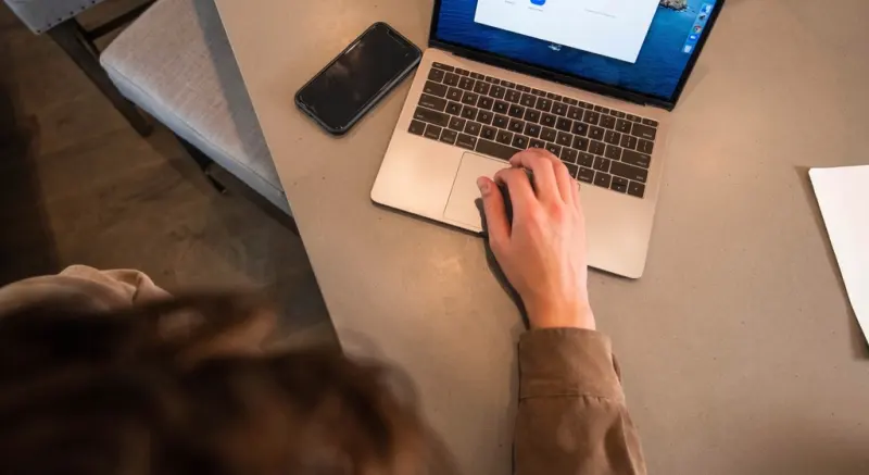 Person completing an online course on a laptop