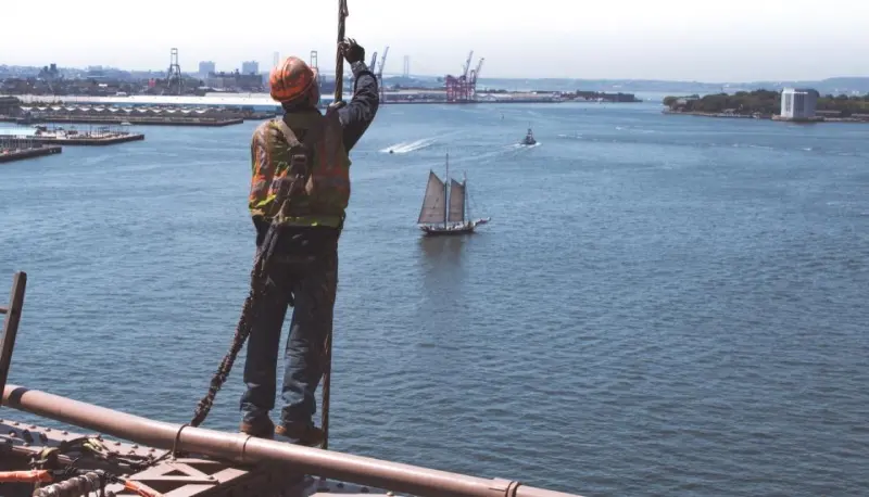 Worker secured on a structure above water
